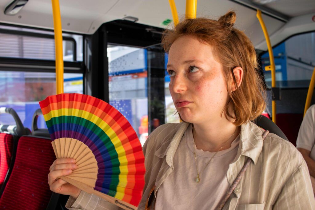 Foto der Autorin im Bus mit einem bunten Fächer